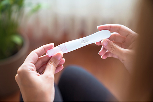 Individual looking at pregnancy test